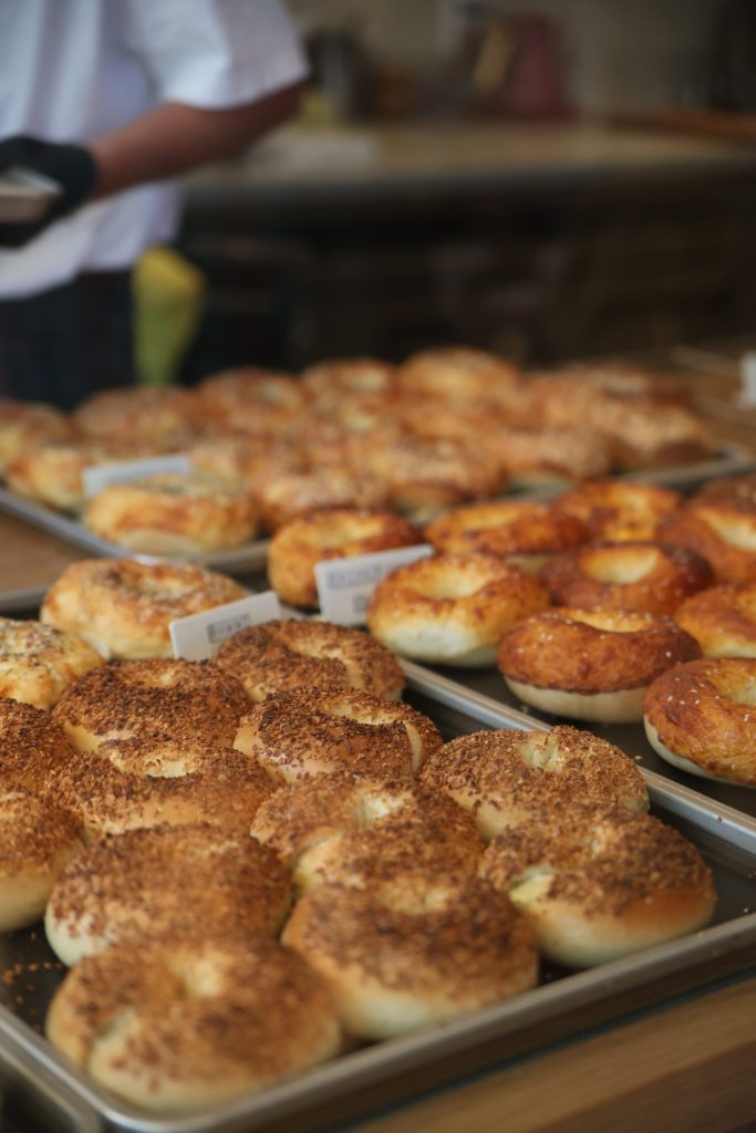 Trays of fresh-baked bagels on display at a Pasadena bakery