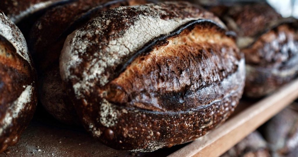 Rustic sourdough bread loaves on a bakery shelf in Pasadena
